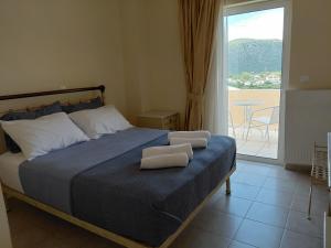 a bedroom with a bed with two towels on it at Irini's Villa in Argostoli +75 photos