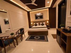 a hotel room with a bed and a table at Hotel Bellamontan Suites Near Delhi Airport - Free Airport Pickup & Drop in New Delhi