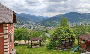 a view of a city from a house with a gazebo at Під зорями in Slavske