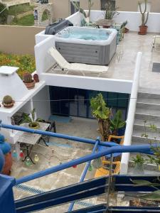 a hot tub sitting on top of a building at 2-Bed Blue & White Apartment with Jacuzzi, BBQ, Garden, near Beach in Platanias