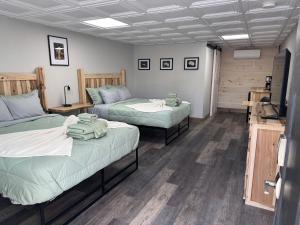 a room with two beds and a tv in it at Raystown Country Lodge in Huntingdon