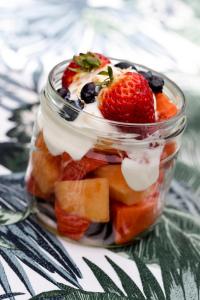 a jar filled with fruit and whipped cream and a strawberry at Sirio in San Francisco