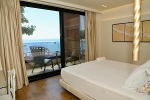 a bedroom with a bed and a view of the ocean at Manolo & Jolie Luxury Villa in Himare