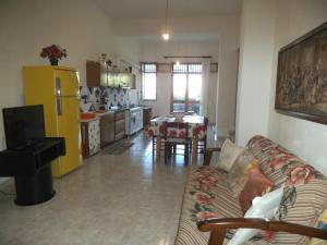 a living room with a couch and a kitchen at Valle Verde 4 Clima & Wi-Fi in Castellammare del Golfo