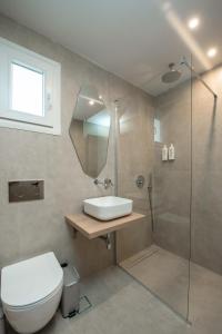 a bathroom with a toilet and a sink and a shower at Sokrates Studios in Afantou