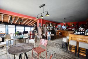 a restaurant with a table and chairs and a bar at Manolo & Jolie Luxury Villa in Himare