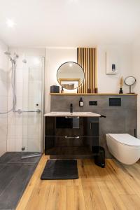 a bathroom with a sink and a toilet and a mirror at Ferienhaus Maarruhe in Schalkenmehren +6 photos