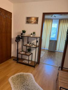 a room with a shelf with potted plants on it at Spessartblick in Heimbuchenthal