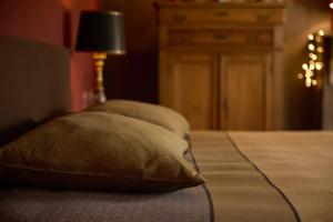 a pillow sitting on top of a bed at B&B Alexandre in Herzele