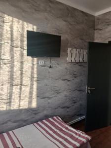 a bedroom with a flat screen tv on the wall at Tyom in Khodzhabegi