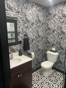 a bathroom with a toilet and a sink at The Station House in Brantford