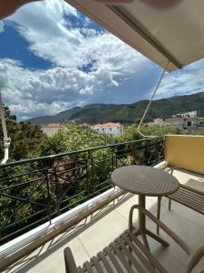 a balcony with a table and chairs and a view at Pelagos Suites in Igoumenitsa