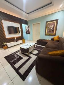 a living room with a couch and a coffee table at Ivory Max in Ikeja