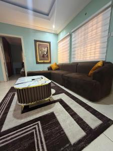 a living room with a couch and a coffee table at Ivory Max in Ikeja