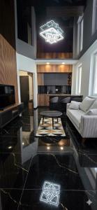 a living room with a couch and a table at Beach Apartment Chakvi in Chakvi