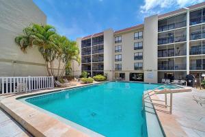a swimming pool in front of a building at Siesta Key Beach - 2 Bedroom - 3 Beds - 3 Bathroom Duplex with Heated Swimming Pool in Siesta Key
