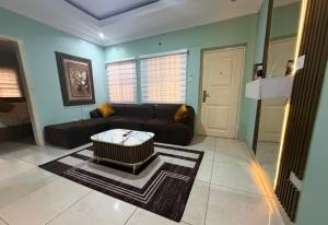 a living room with a couch and a coffee table at Ivory Max in Ikeja