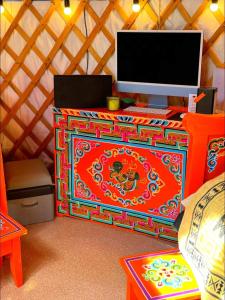 a colorful desk with a computer on top of it at Healing stay hostel in Dzuunmod