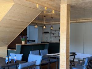 a restaurant with wooden ceilings and tables and chairs at Healing stay hostel in Dzuunmod