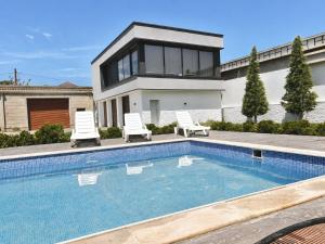 a house with a swimming pool in front of a house at PoolSummerHouse in Baku