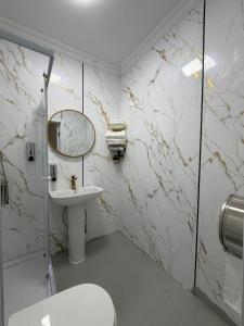 a bathroom with a toilet and a sink and a mirror at Healing stay hostel in Dzuunmod +31 photos