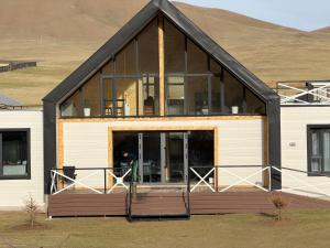 a house with large glass windows on the front of it at Healing stay hostel in Dzuunmod