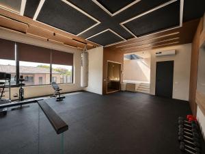 an empty room with a gym with a chair and a treadmill at PoolSummerHouse in Baku