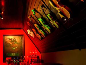 a room with red lighting and a wall with green lights at Dunajec Mansion in Czchów