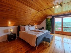 a bedroom with a large bed and a wooden ceiling at Dunajec Mansion in Czchów