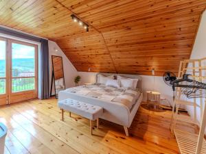 a bedroom with a bed and a wooden ceiling at Dunajec Mansion in Czchów