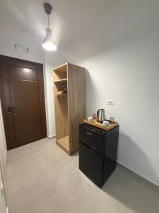 a kitchen with a black counter and a wooden cabinet at Sofia Studios in Benitses +44 photos