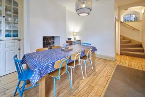 a dining room with a blue table and chairs at Sandy Toes in Sandsend