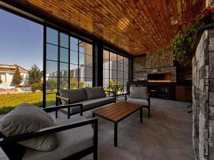a living room with a couch and a table at PoolSummerHouse in Baku