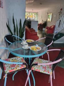 a glass table with two chairs and a plate of food at CASA FLOR DE LIZ in Villavieja