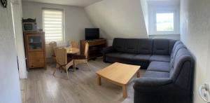 a living room with a couch and a table at Ferienwohnung Sauerländer in Plettenberg