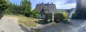 a house sitting on a hill next to a house at Ferienwohnung Sauerländer in Plettenberg