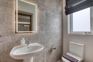 a bathroom with a sink and a toilet at Spacious and refined 3 bedroom duplex KARP1-1 in San Ġwann +27 photos