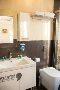 a bathroom with a sink and a toilet and a mirror at The Moonlight Luxury Hotel in Baku +19 photos