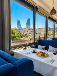 a table in a restaurant with a view of the city at The Moonlight Luxury Hotel in Baku