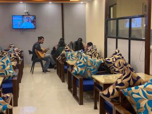 a group of people sitting in a waiting room at Peace Hostel in Kathmandu