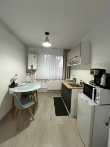 a kitchen with a table and a small table with a table at Casa Bocan in Geoagiu Băi