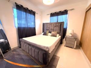a bedroom with a large bed with black curtains at Cange in Albana