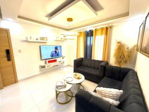 a living room with a couch and a tv at Cange in Albana +5 photos
