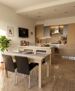 a kitchen with a large wooden table and chairs at Azzurro Garda in Sirmione