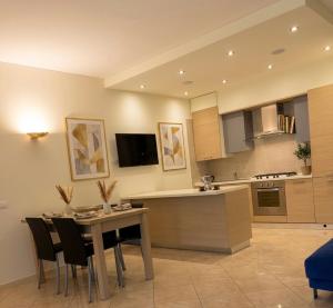 a kitchen and dining room with a table and chairs at Azzurro Garda in Sirmione +10 photos