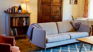 a living room with a couch and a book shelf at Maison Thoumieu in Azereix