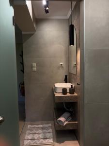a bathroom with a sink and a mirror at Filemial House in Agios Mamas +22 photos