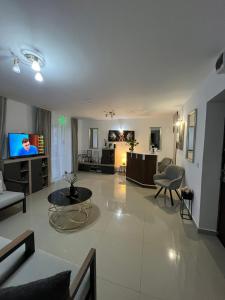 a large living room with a couch and a tv at Casa Bocan in Geoagiu Băi