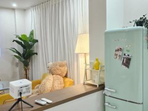 a kitchen with a refrigerator and a stuffed bear at 스테이149 in Hyomoktong-Ilgu