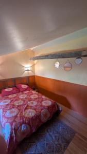 a bedroom with a bed and two lights on the wall at La demeure de vos désirs in Pressac